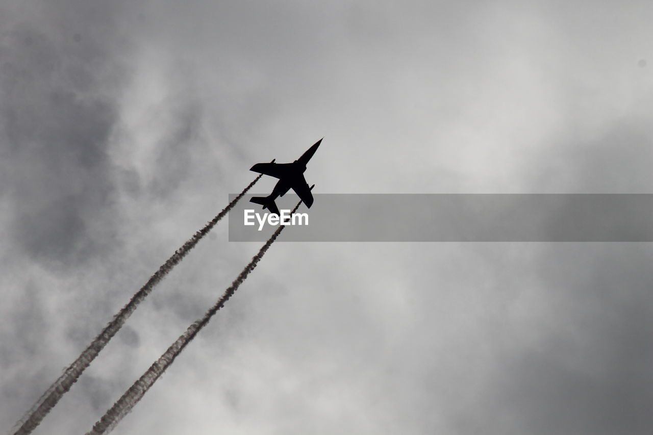 LOW ANGLE VIEW OF AIRPLANE IN SKY