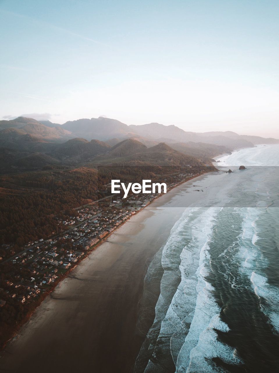 Scenic view of sea and mountains against sky