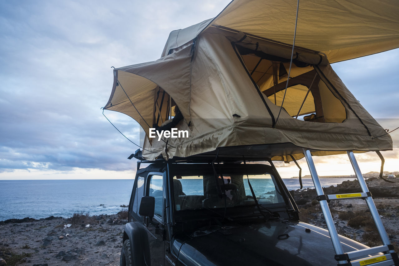 Tent on car against sky