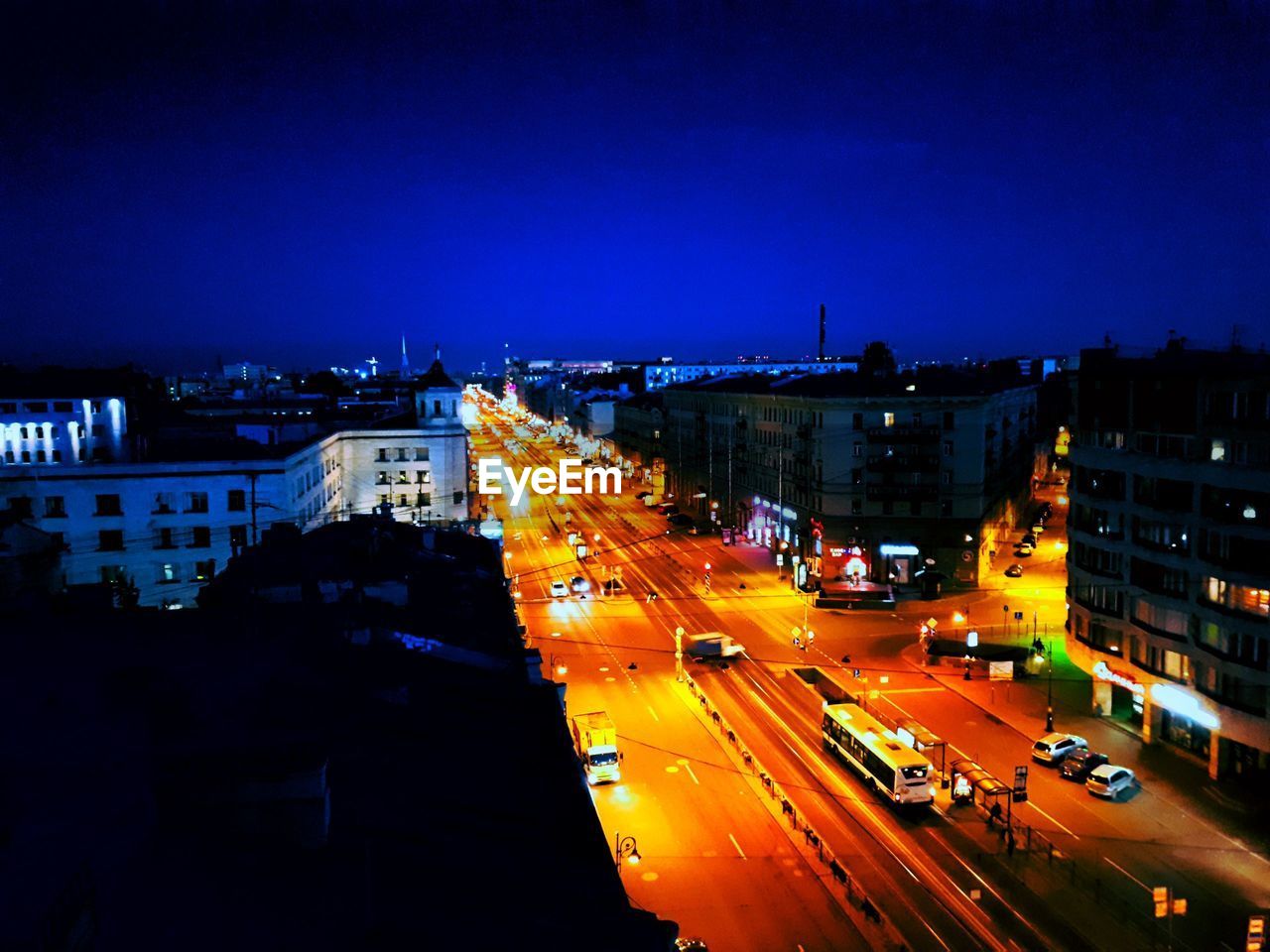 HIGH ANGLE VIEW OF LIGHT TRAILS ON ROAD IN CITY