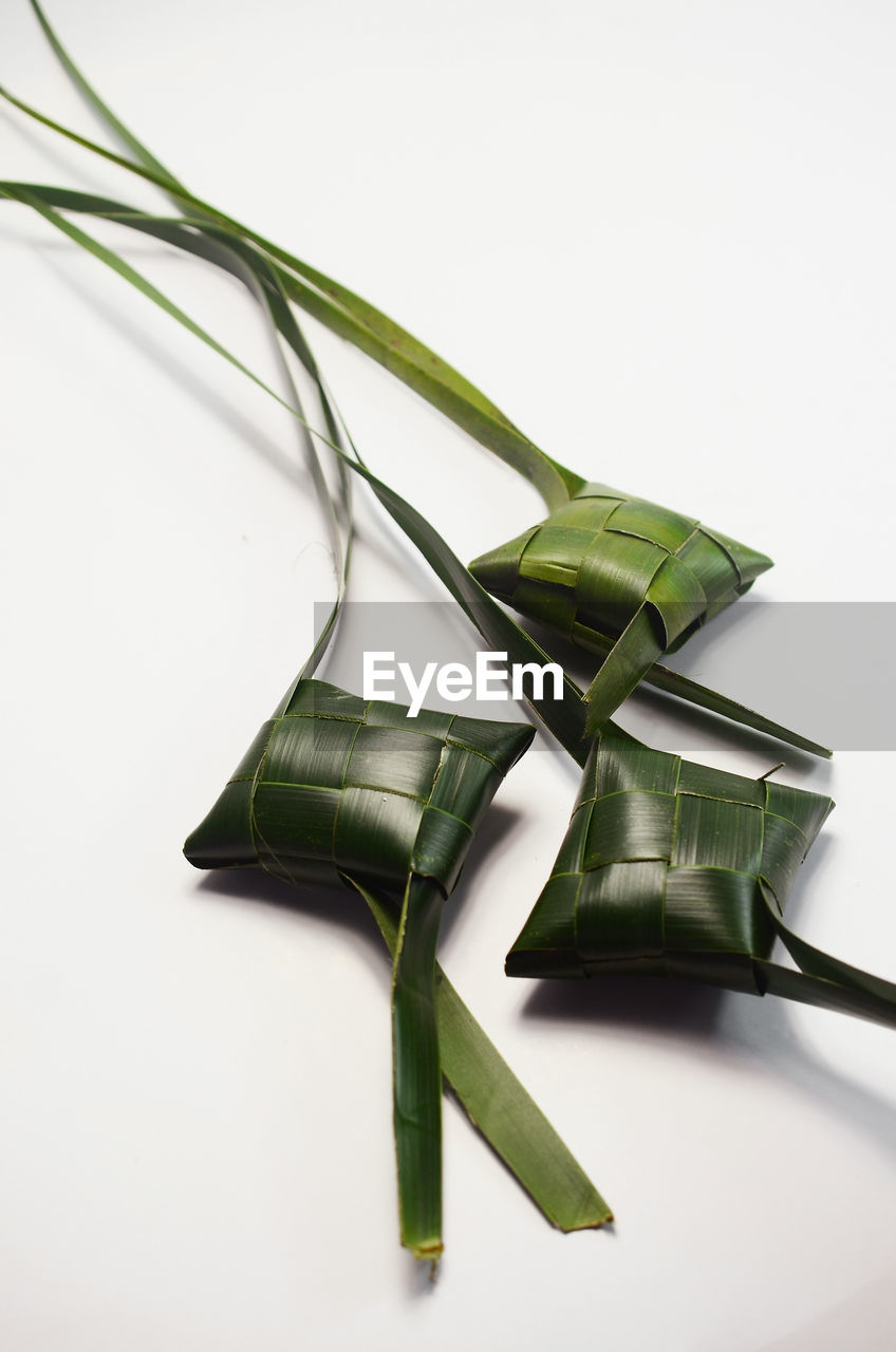 Ketupat or rice dumpling on white table background