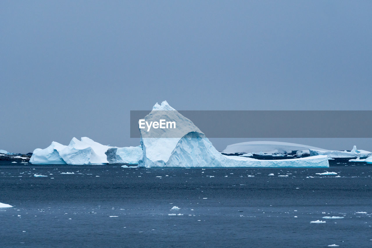 Scenic view of icebergs against sky