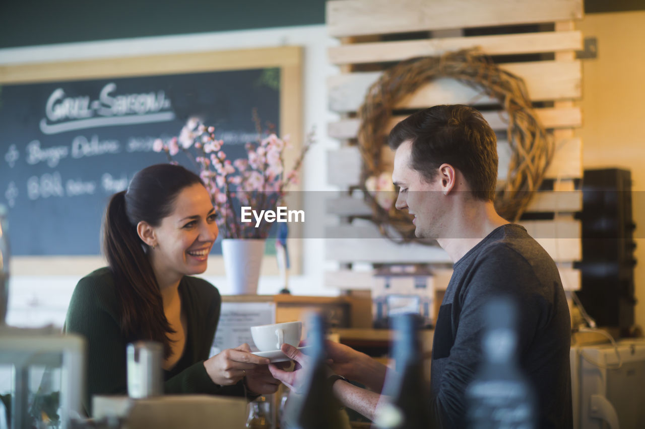 Young couple in a restaurant in love drinking coffee