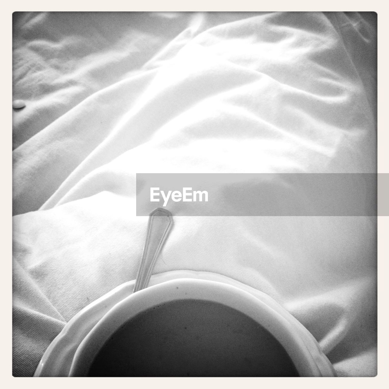 Cup of coffee on bedding