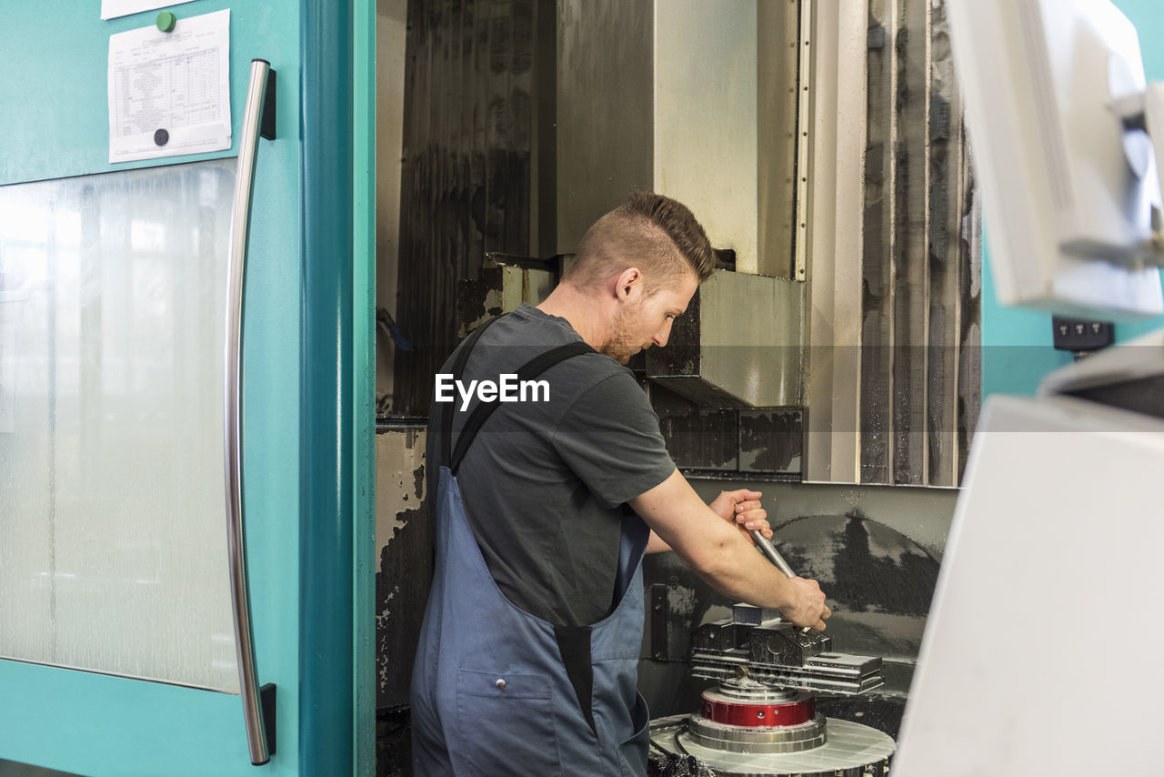 Man working at machine in factory