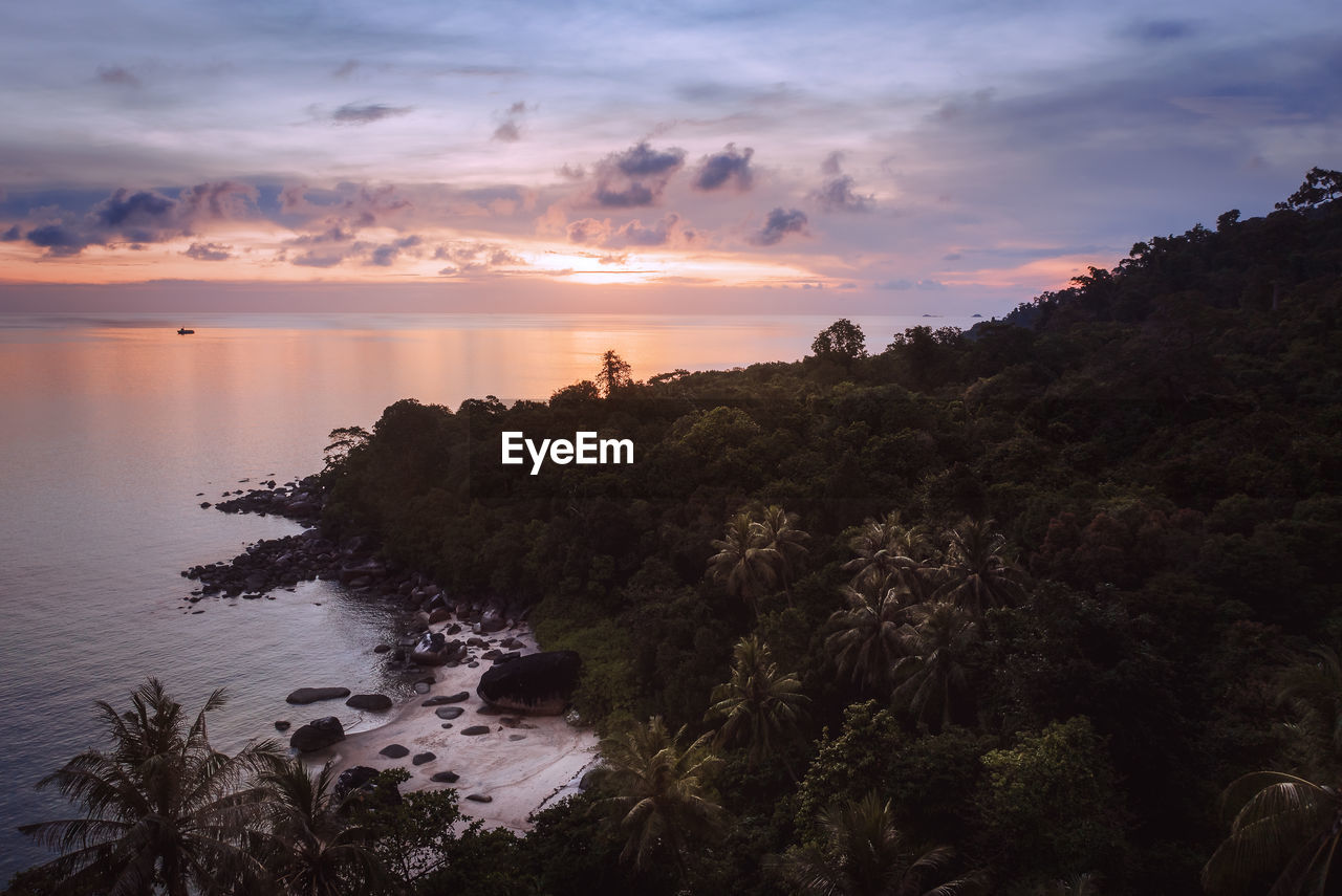 Aerial view of golden sunset over secret secluded tropical island beach, koh adang, thailand