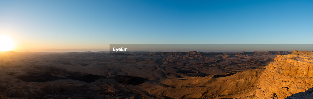 AERIAL VIEW OF DRAMATIC LANDSCAPE AGAINST CLEAR SKY