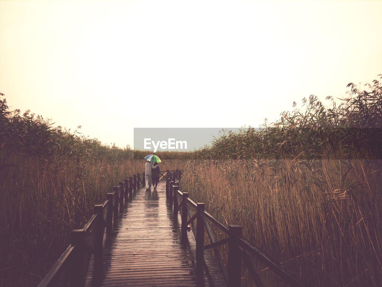 Couple moving on boardwalk