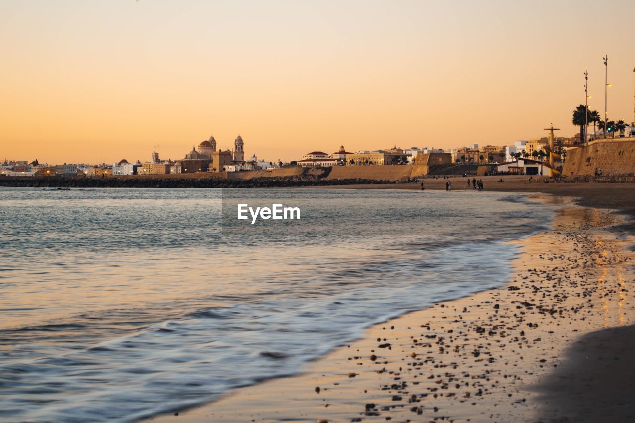 Scenic view of sea against clear sky during sunset