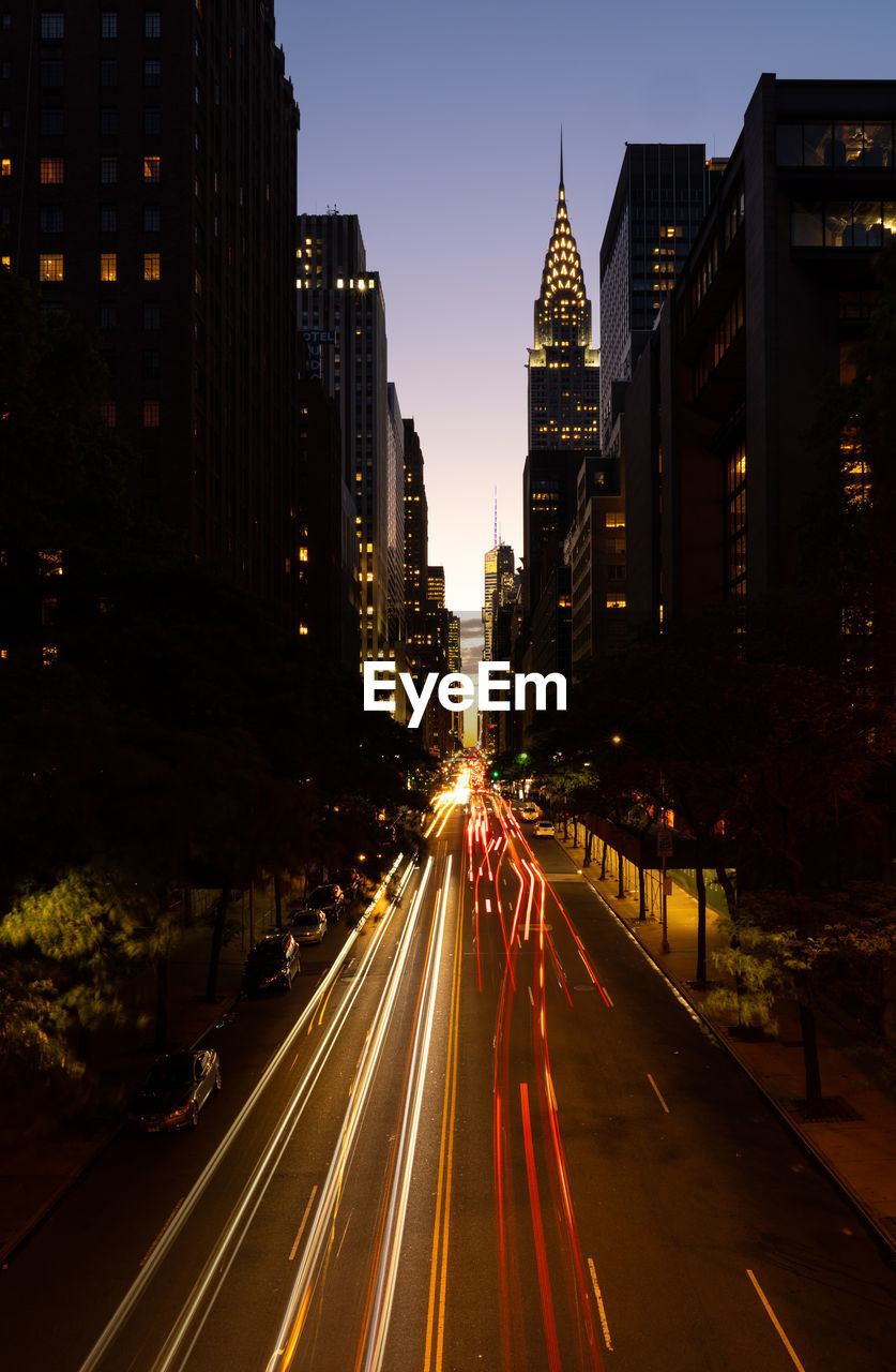 Light trails on road in city at night