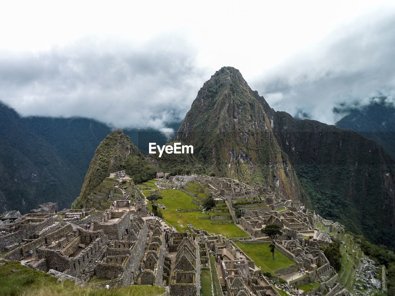 View of ruins of mountain against cloudy sky