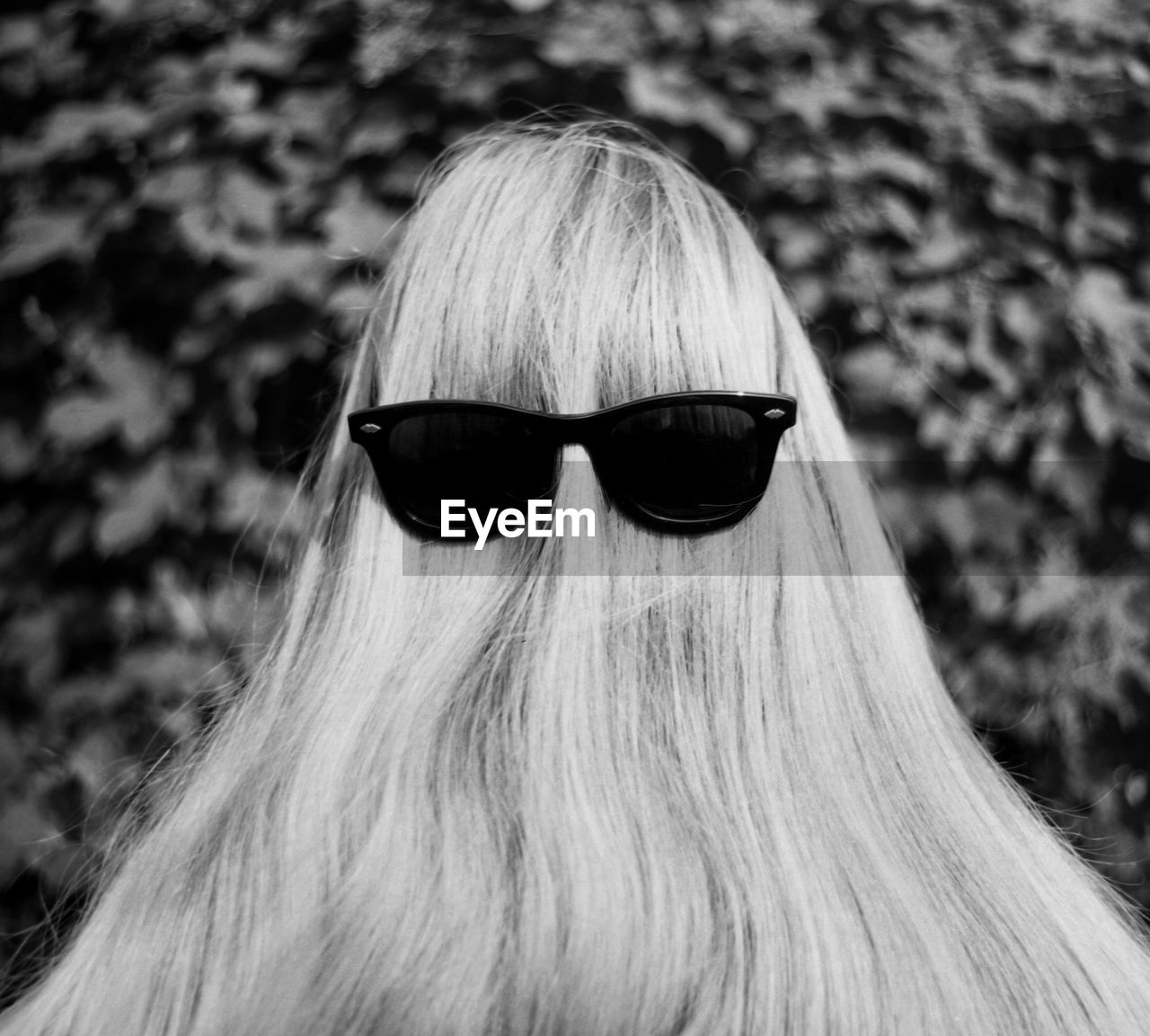 Rear view of woman wearing sunglasses over hair