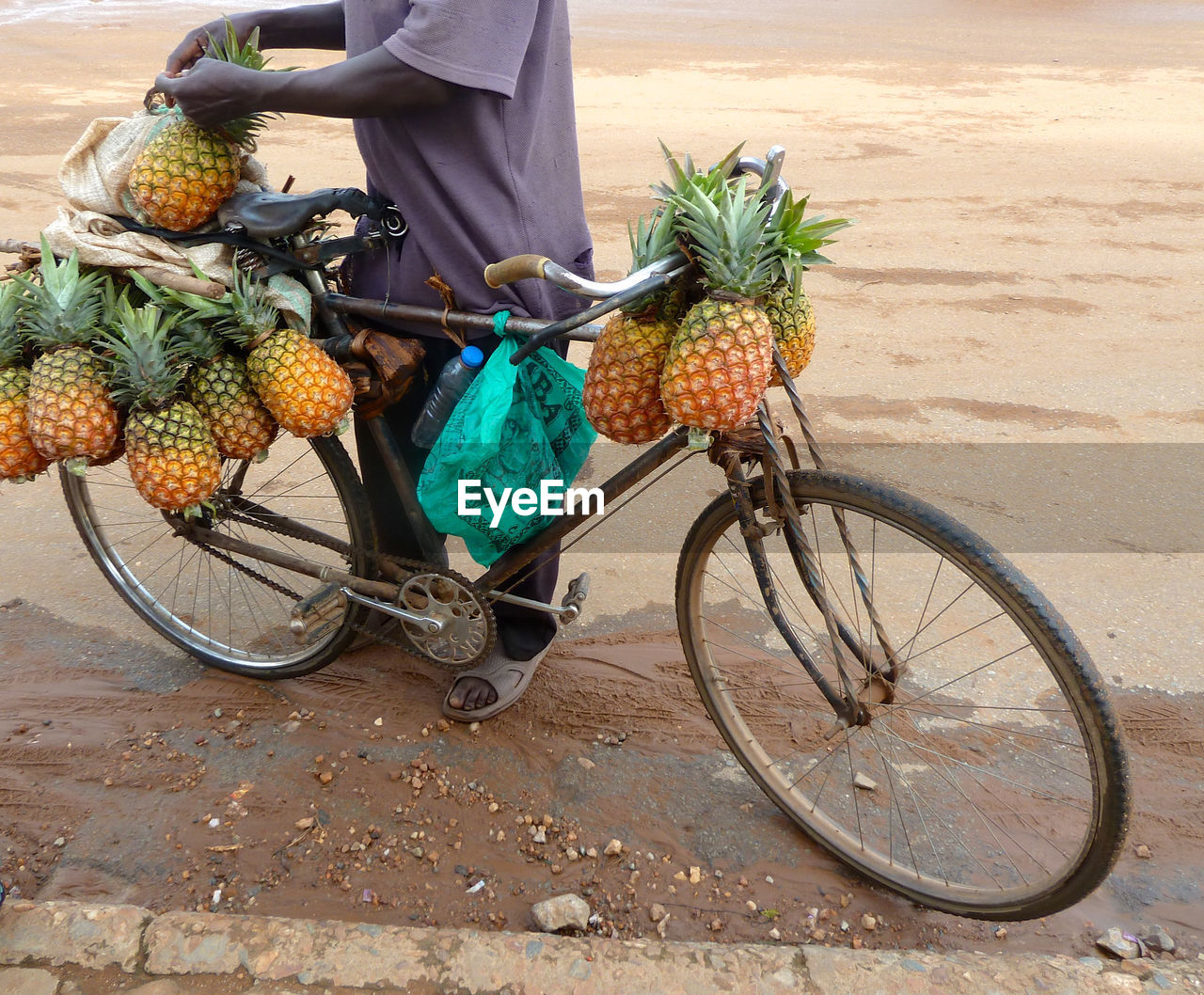 Low section of woman standing on bicycle