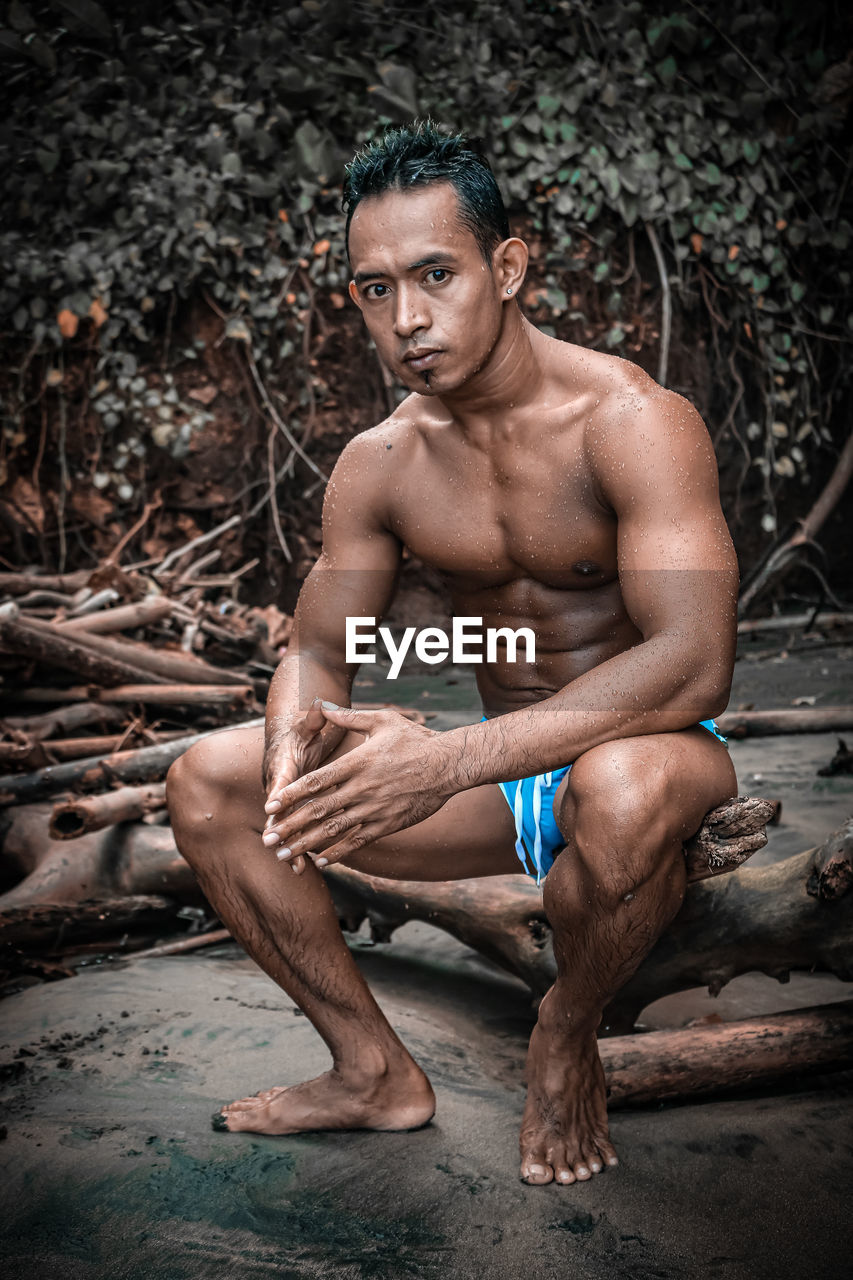 Portrait of young muscle men on the beach