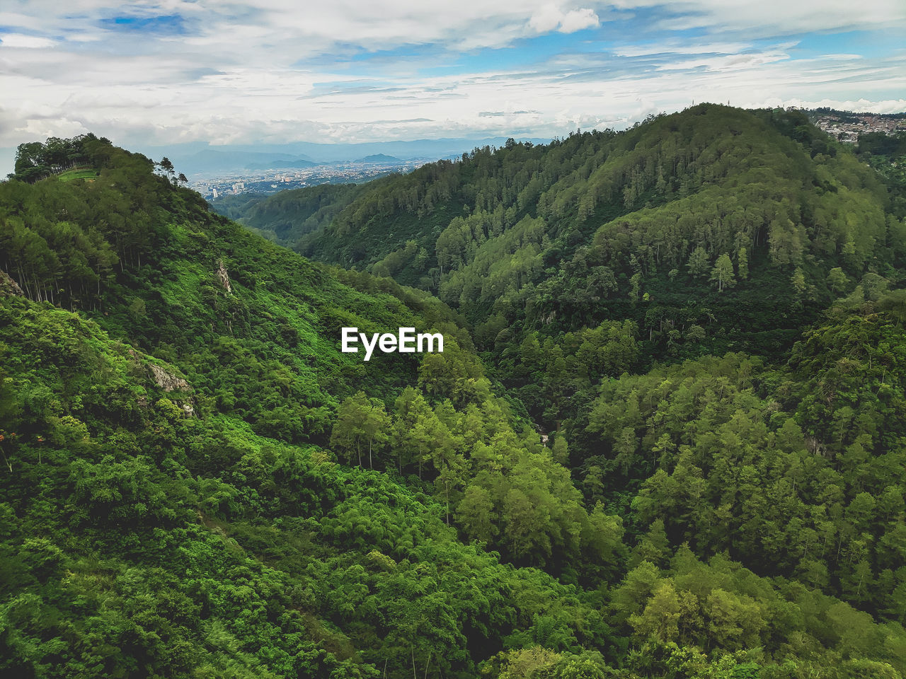 Scenic view of green mountains against sky