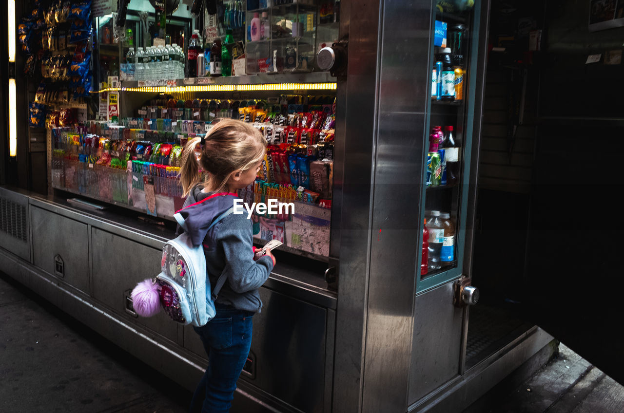 WOMAN LOOKING AT STORE