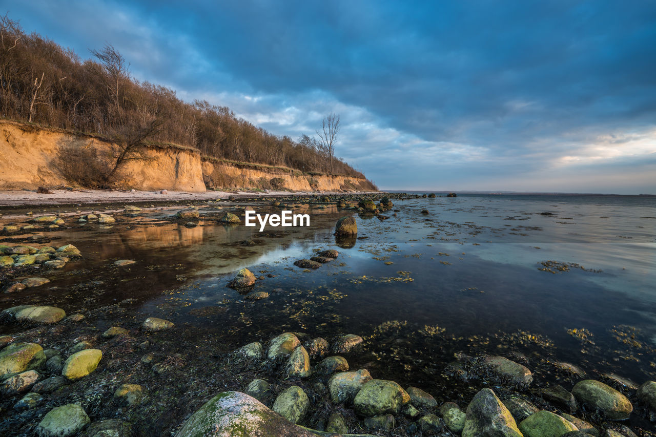 Scenic view of sea against cloudy sky