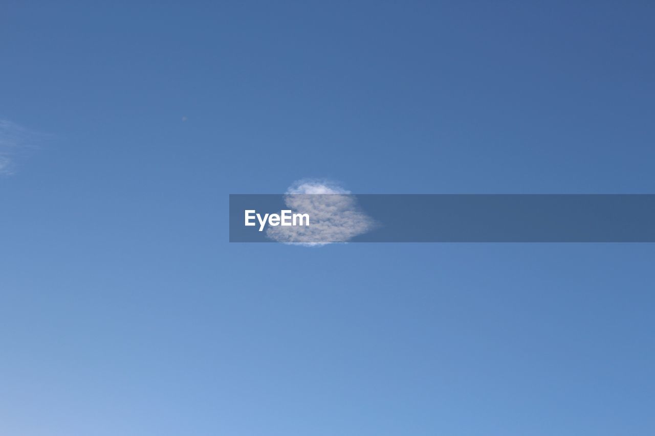 Low angle view of moon in blue sky