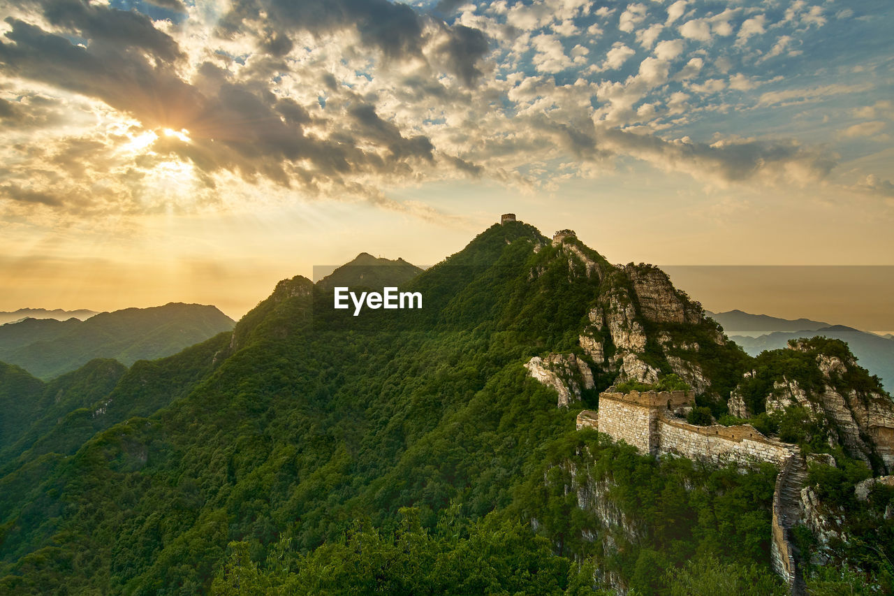 Scenic view of mountains against cloudy sky