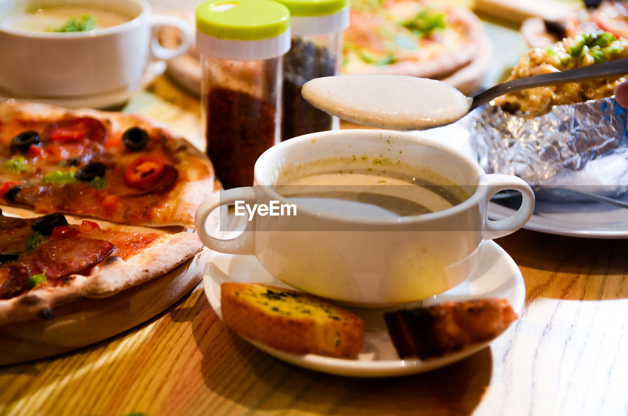 CLOSE-UP OF BREAKFAST SERVED WITH COFFEE AND SPOON