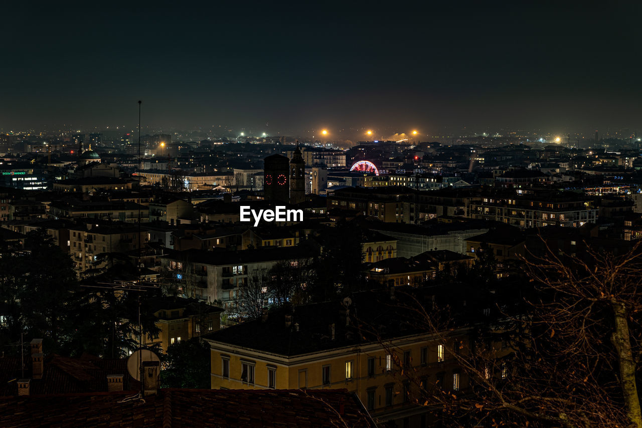 HIGH ANGLE VIEW OF ILLUMINATED BUILDINGS AGAINST SKY