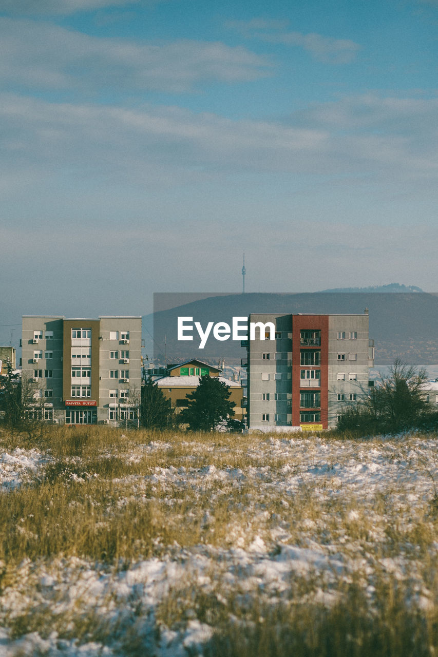 Buildings in city against sky