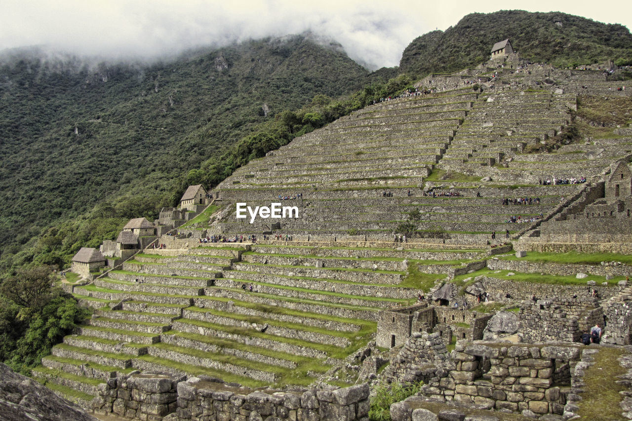 HIGH ANGLE VIEW OF OLD RUINS IN MOUNTAINS