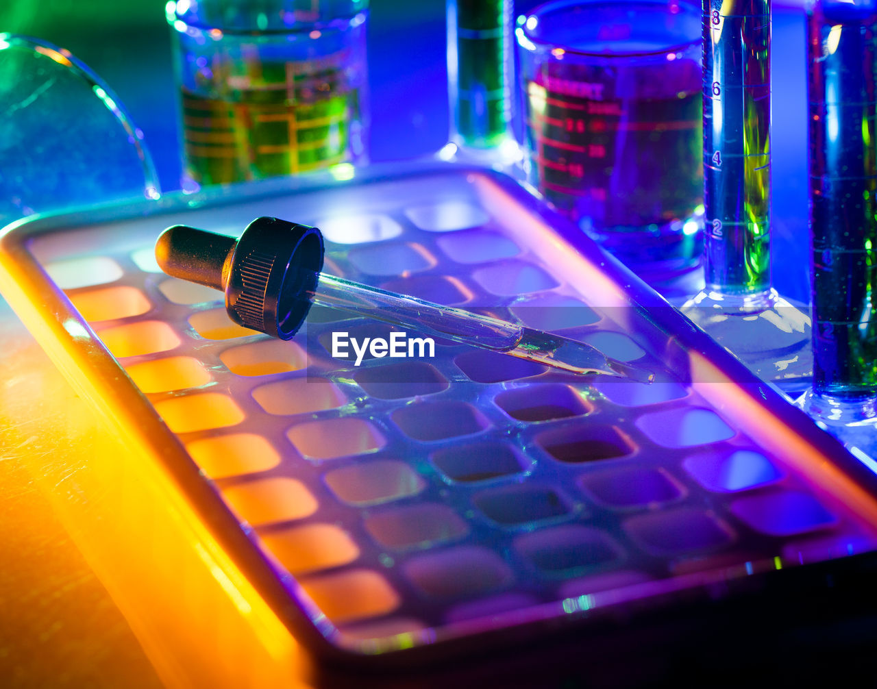 CLOSE-UP OF ILLUMINATED LIGHTING EQUIPMENT ON SHELF