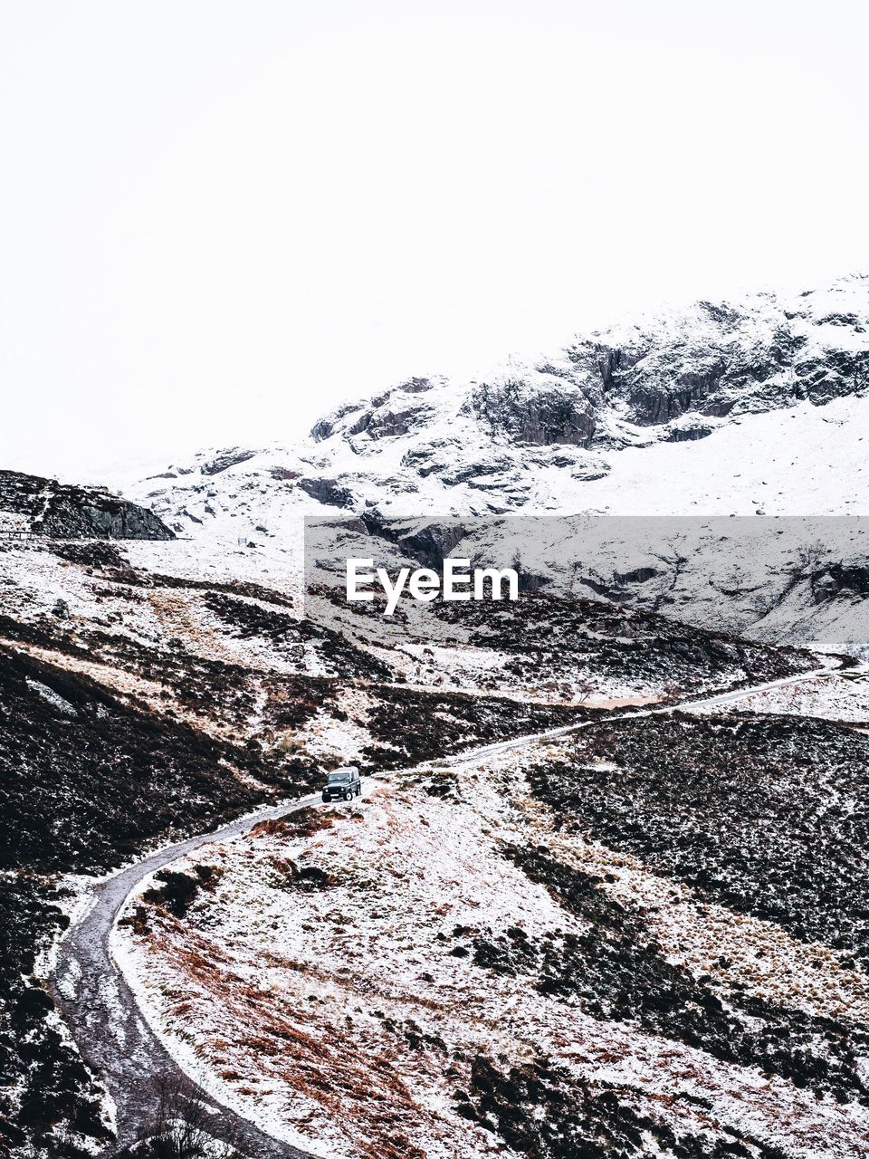 High angle view of road leading towards mountain during winter