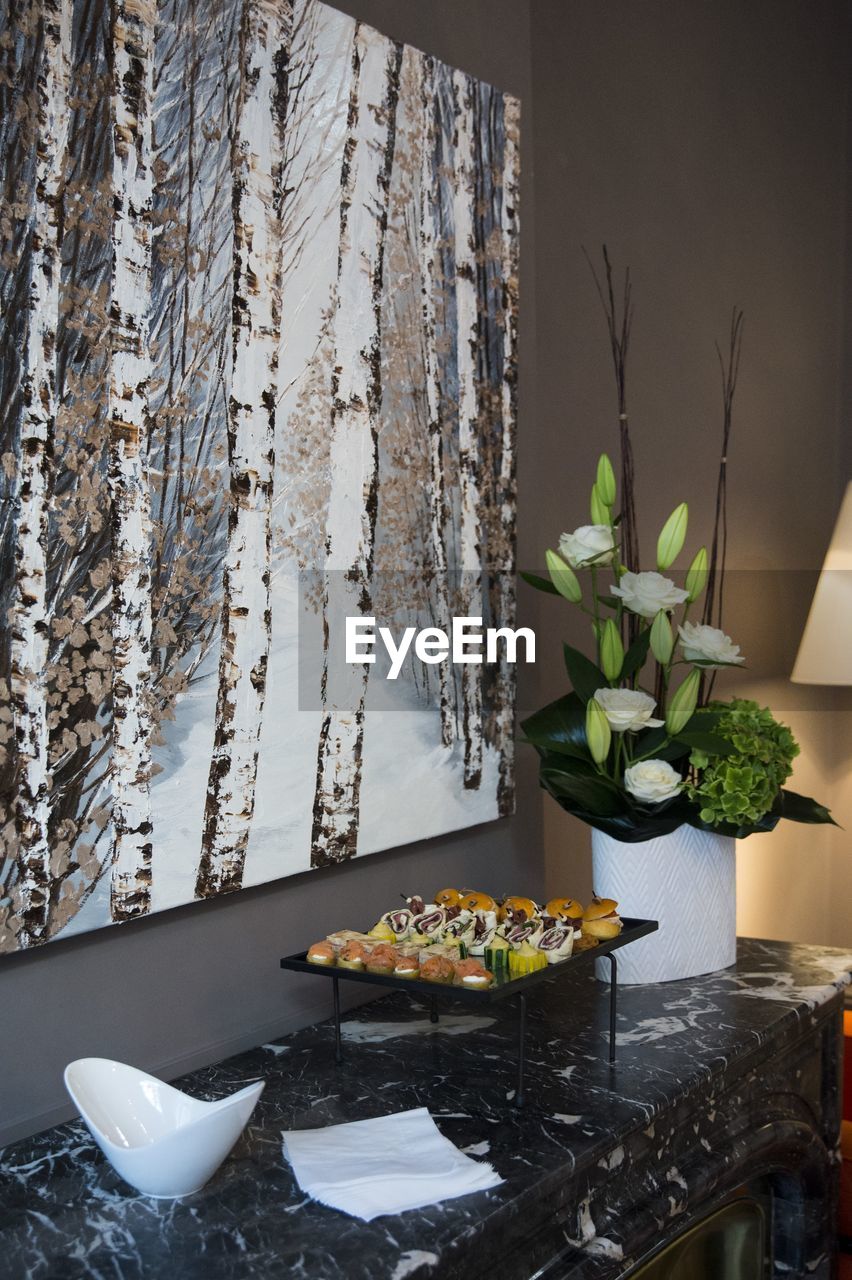 CLOSE-UP OF POTTED PLANTS ON TABLE