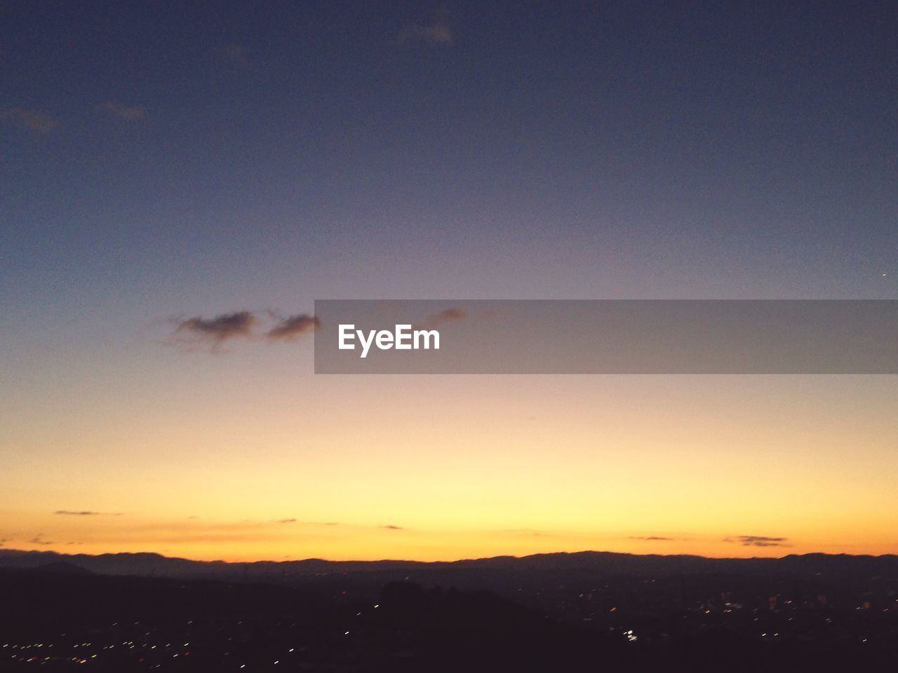 SCENIC VIEW OF MOUNTAINS AT SUNSET