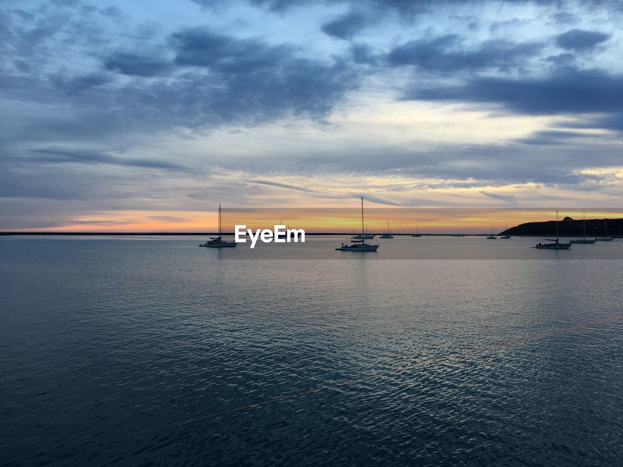 Scenic view of sea against sky at sunset