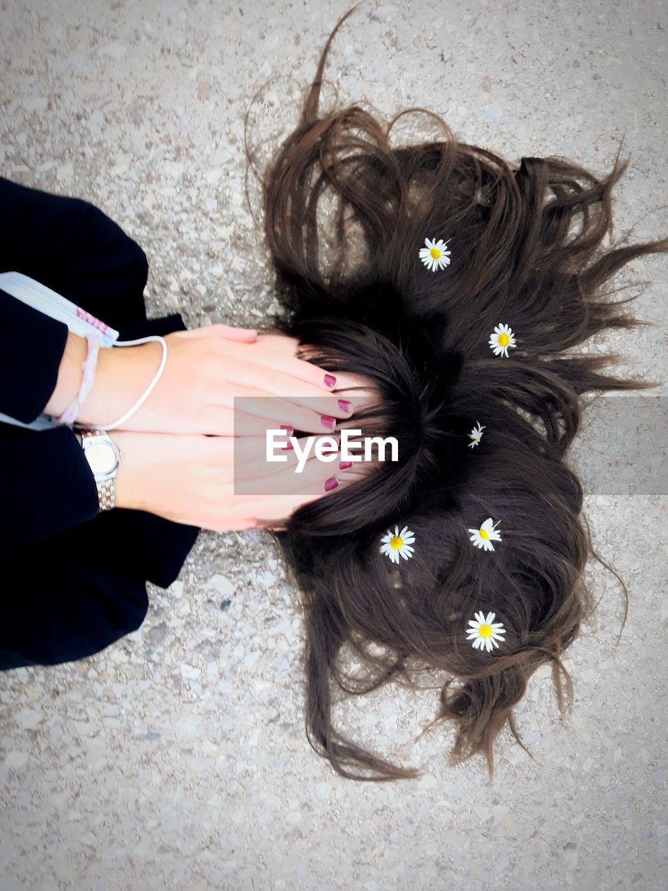 High angle view of woman with flowers in hair