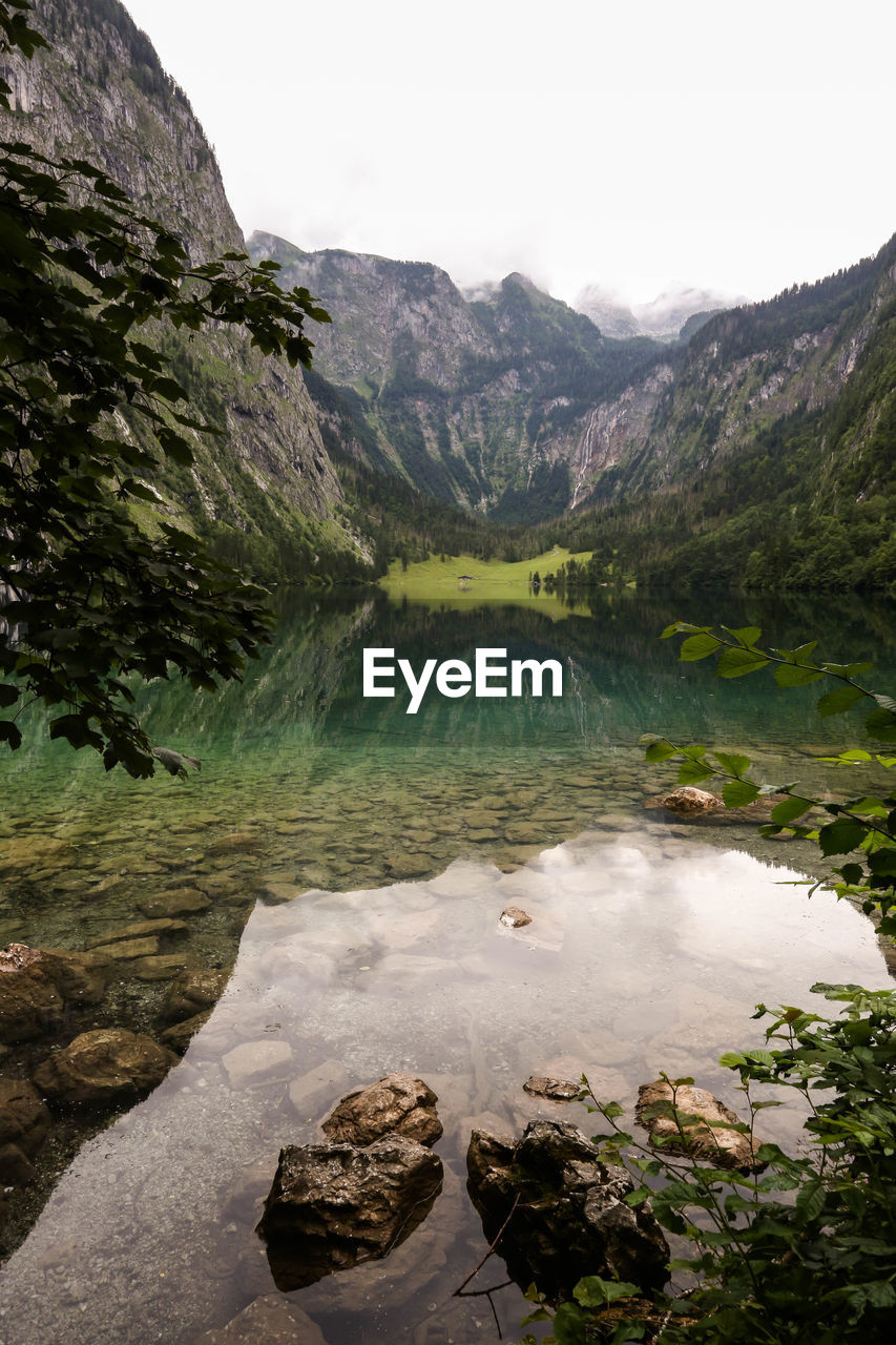 Scenic view of lake and mountains against sky