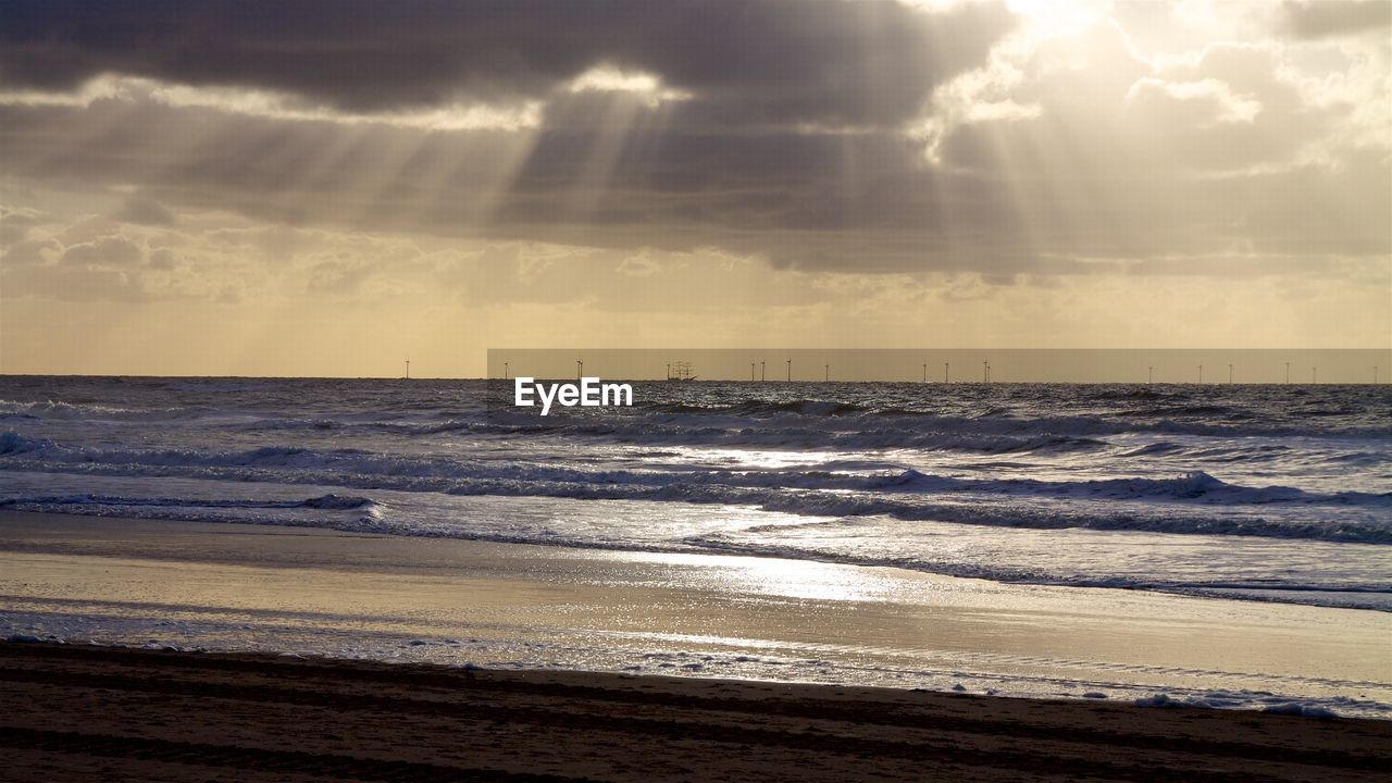 Scenic view of calm sea at sunset