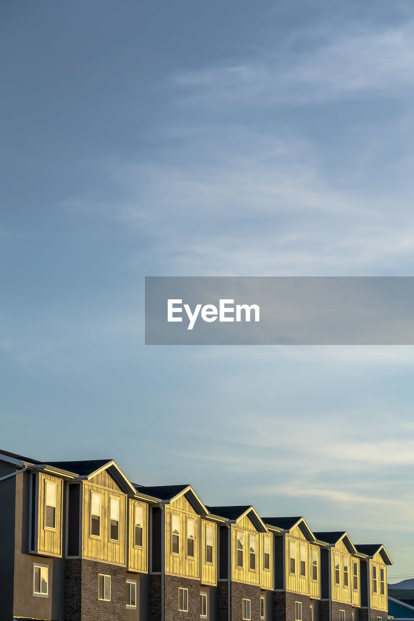 LOW ANGLE VIEW OF HOUSES AGAINST SKY