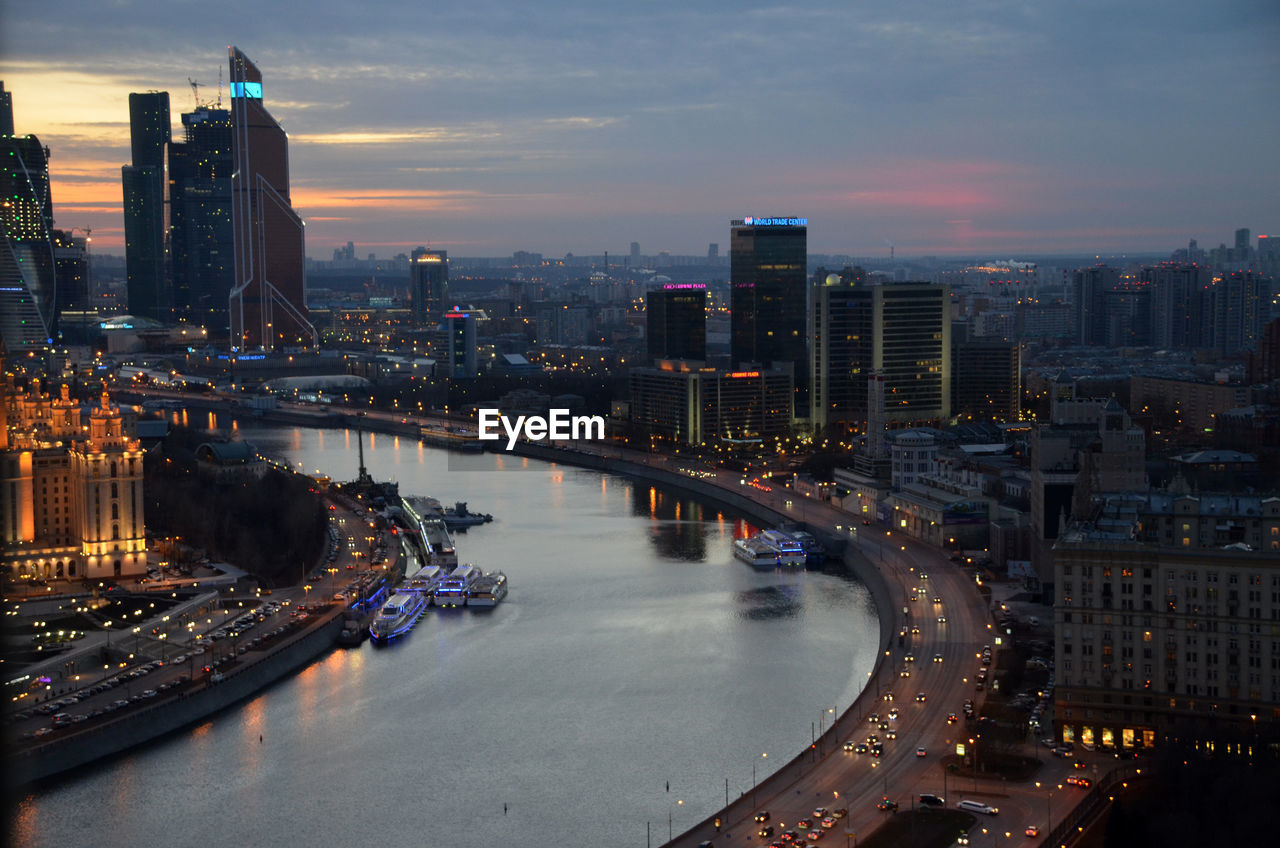 High angle view of city lit up at night