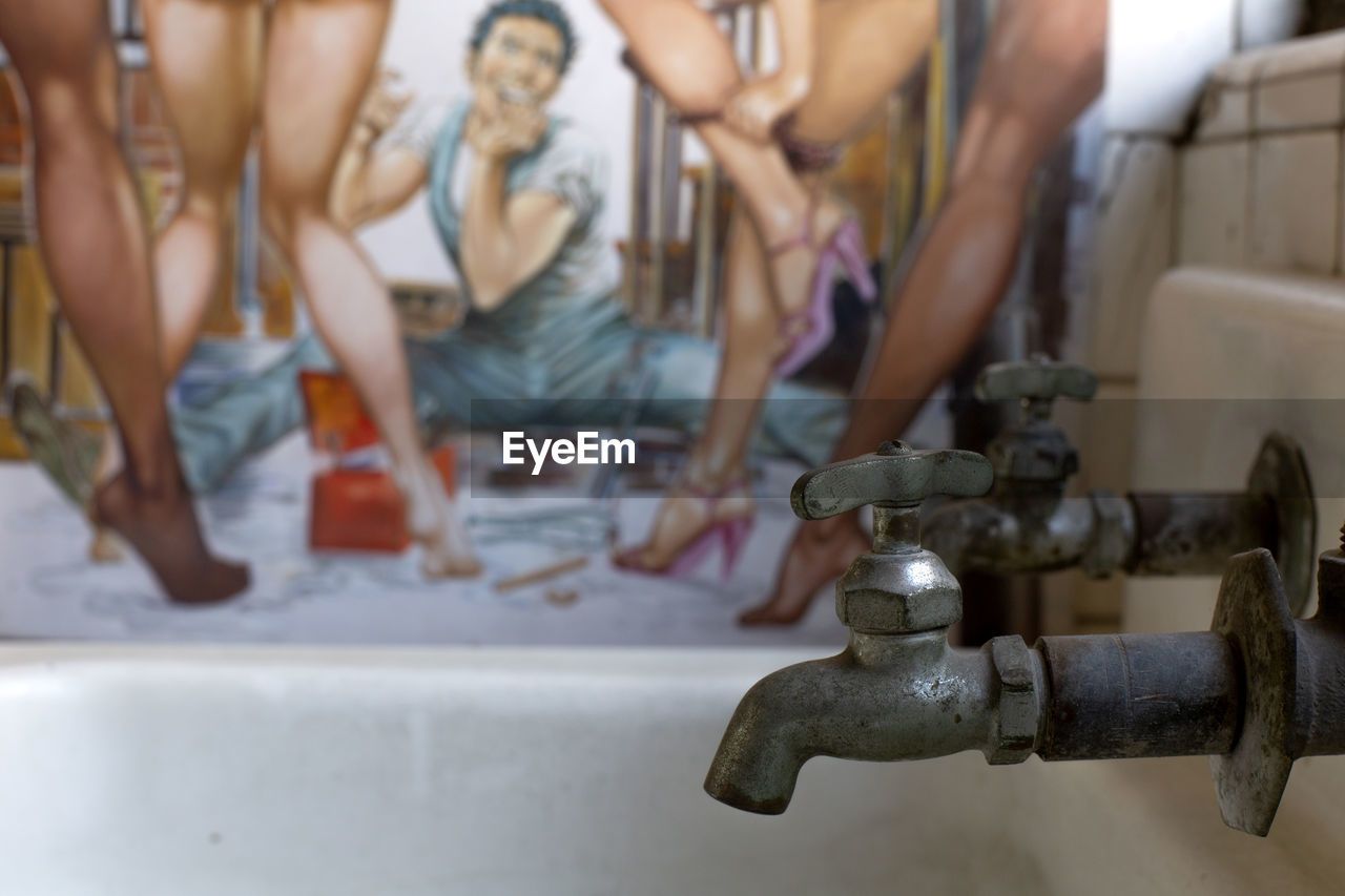Close up of faucet with image of macho in the background