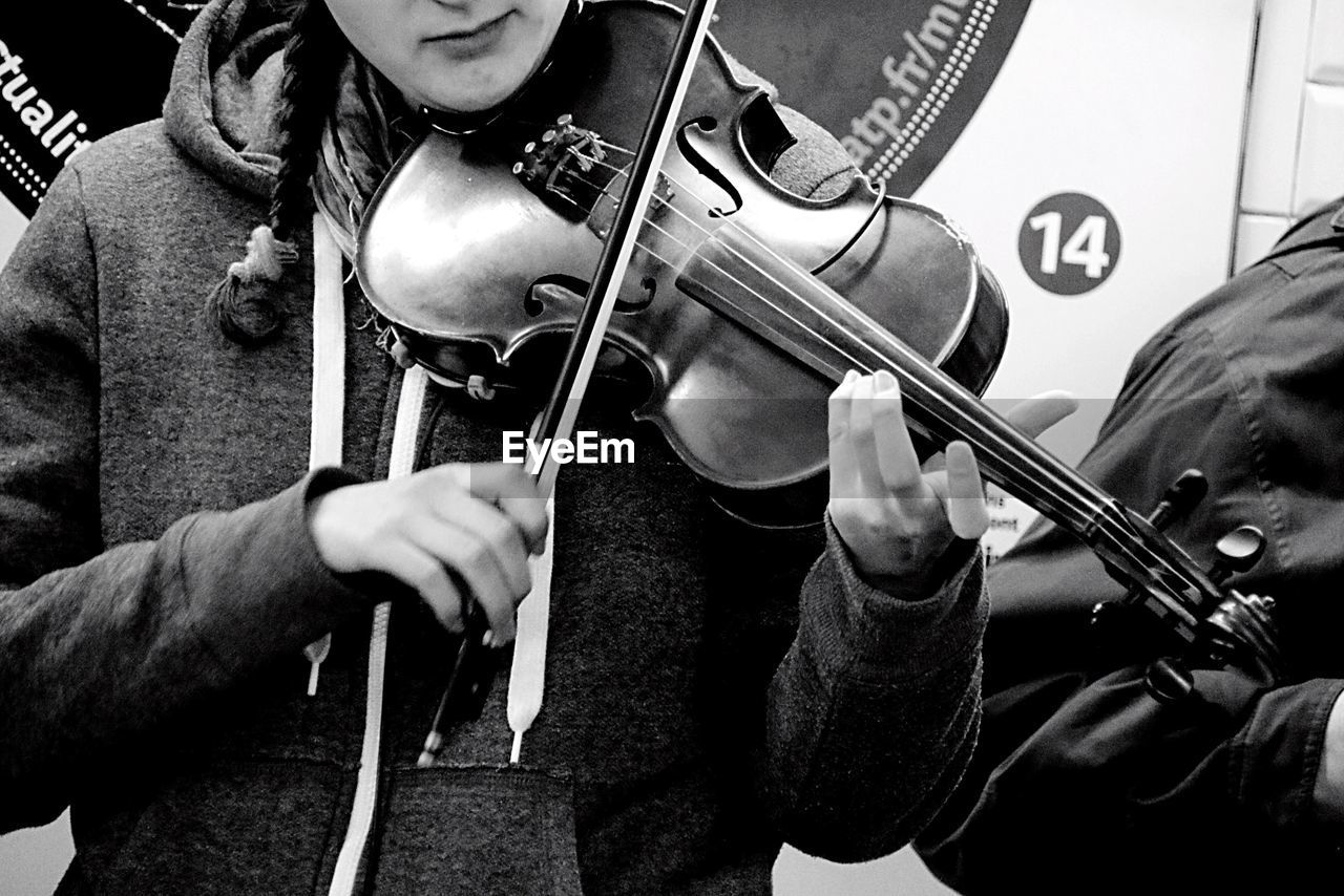 Close-up of woman playing violin