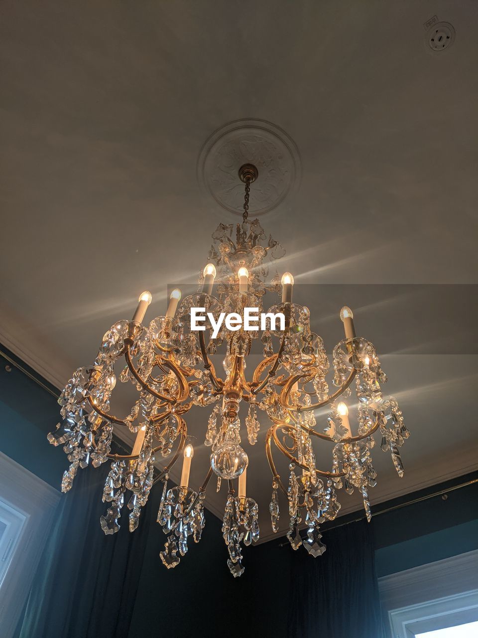 chandelier, light fixture, ceiling, lighting equipment, hanging, wealth, luxury, lighting, illuminated, indoors, low angle view, no people, decoration, light, elegance, electricity, architecture, glowing, light - natural phenomenon, home interior, pendant light, built structure, shiny, ornate, electric light