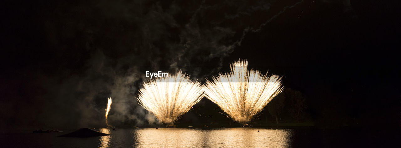 Firework display over lake at olympiapark during night