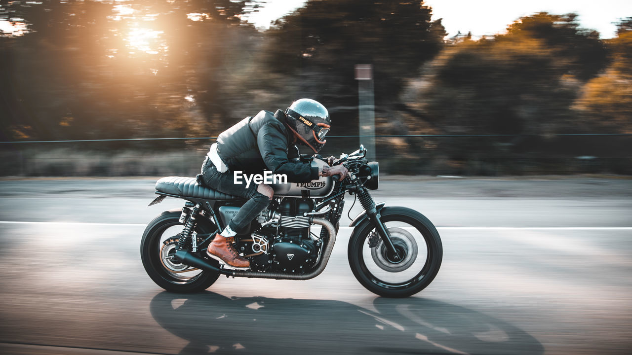 FULL LENGTH OF MAN RIDING MOTORCYCLE