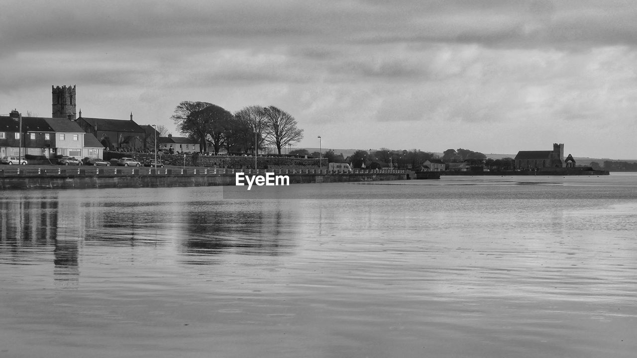 water, architecture, built structure, sky, black and white, building exterior, cloud, monochrome photography, nature, monochrome, building, city, reflection, travel destinations, sea, shore, no people, tree, horizon, outdoors, land, landscape, environment, day, waterfront, history, coast, travel, the past, tourism, plant, waterway