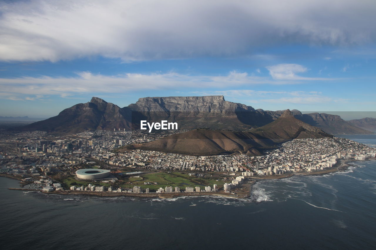 Scenic view of cape town from sea against cloudy sky