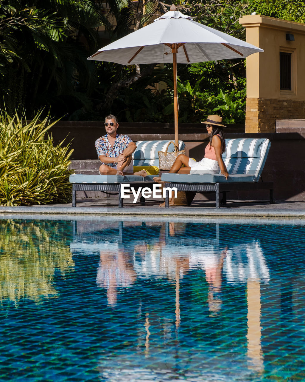 rear view of man swimming in pool