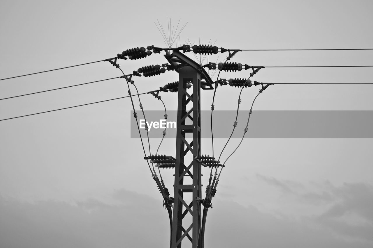 SILHOUETTE ELECTRICITY PYLON AGAINST SKY