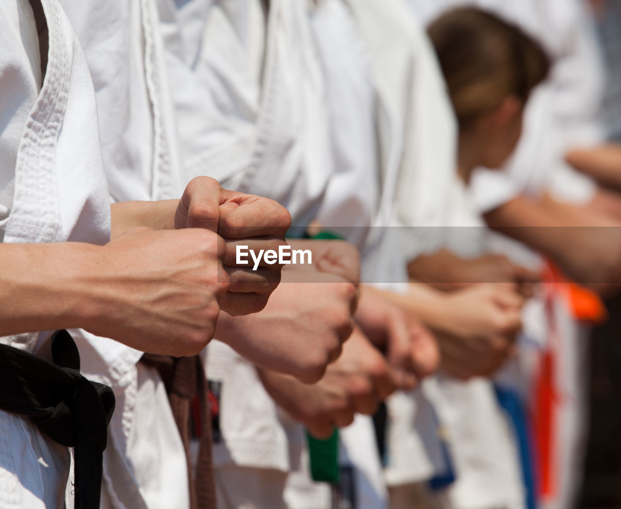 Midsection of people performing karate