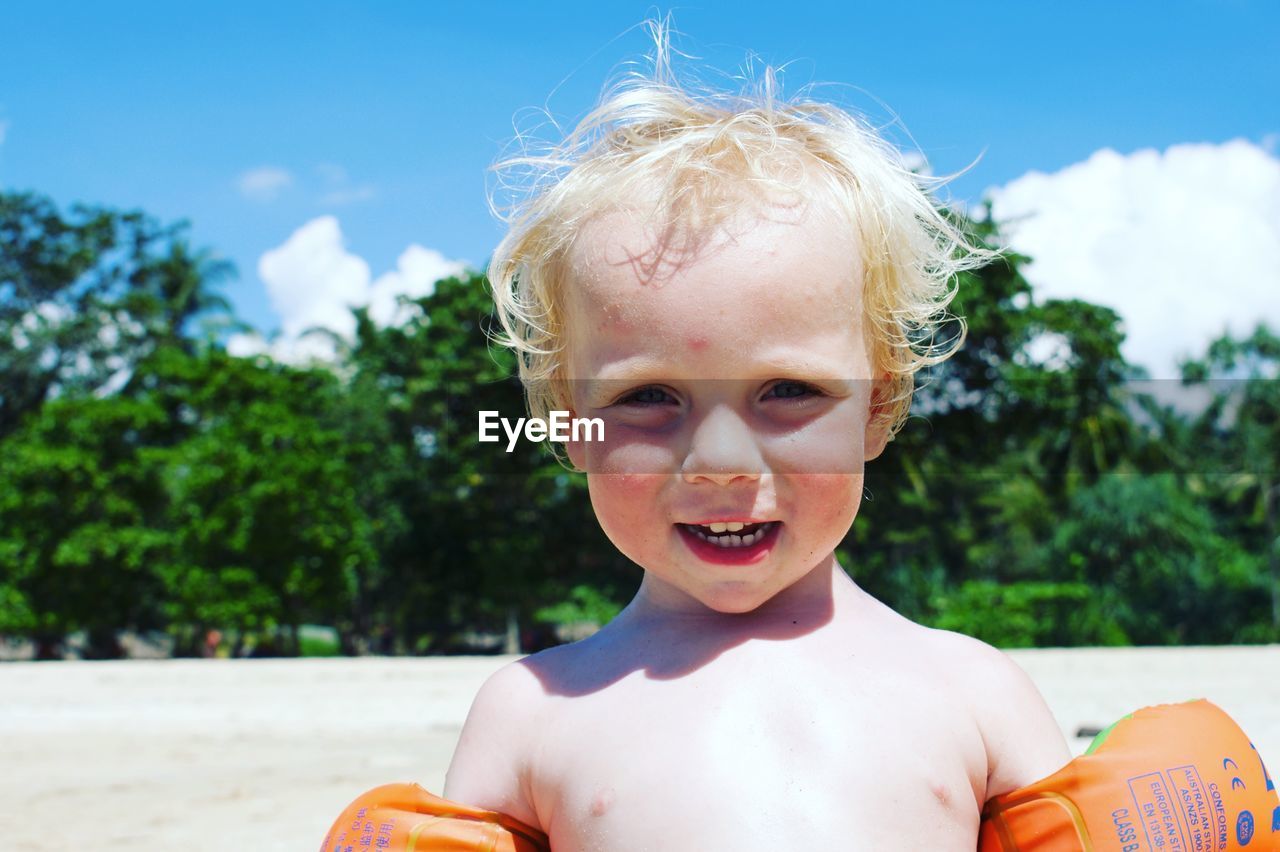 Portrait of cute boy at shore of beach 