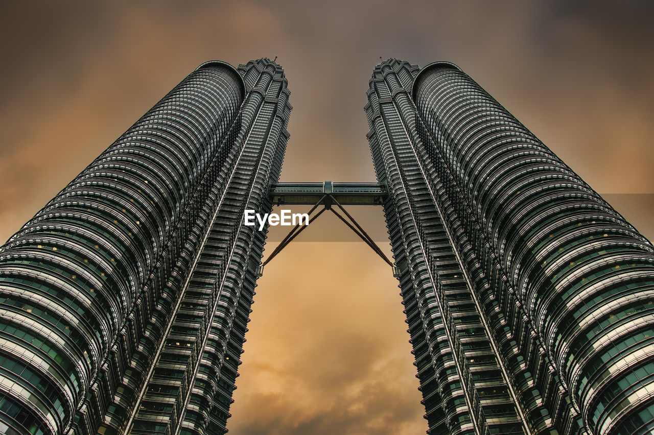 Low angle view of modern buildings against sky during sunset