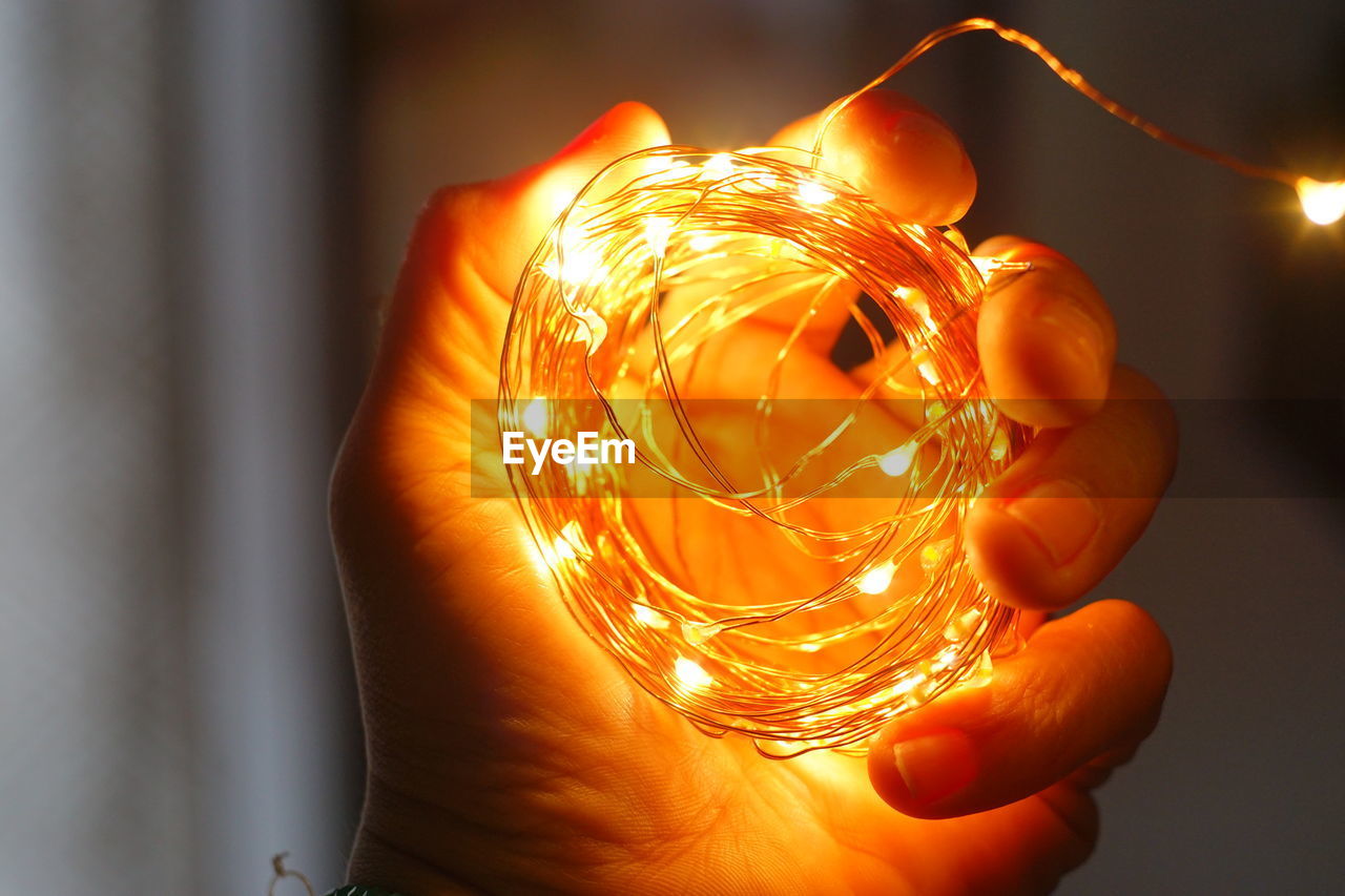 Close-up of hand holding illuminated light